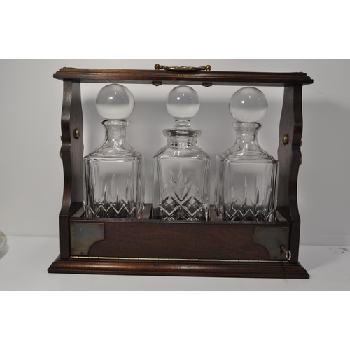 41 - Vintage mahogany and brass tantalus with three cut glass decanters (with key) together with three ot... 