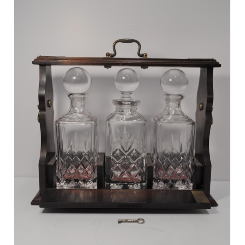 41 - Vintage mahogany and brass tantalus with three cut glass decanters (with key) together with three ot... 