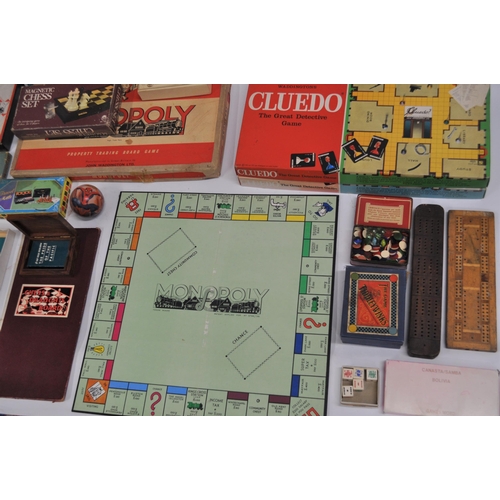 59 - Board games to include vintage Monopoly, Tiddlywinks, and in excess of 70 advertising playing card p... 