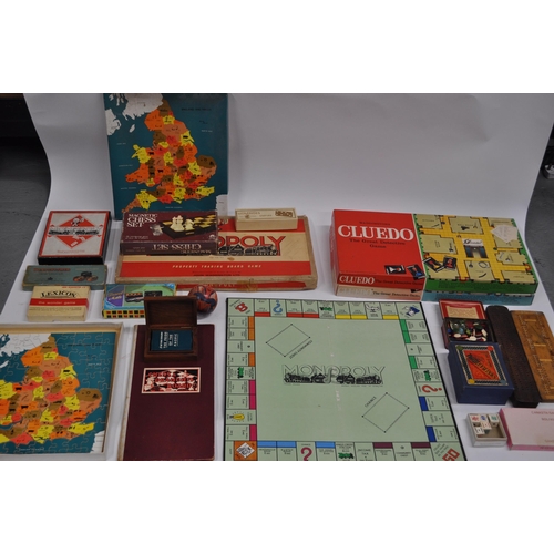 59 - Board games to include vintage Monopoly, Tiddlywinks, and in excess of 70 advertising playing card p... 