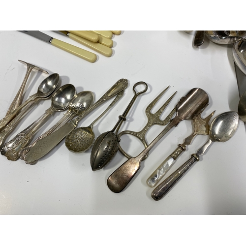 36 - A quantity of antique and vintage silverplate items inc. biscuit barrel, teapot, ladles, flatware et... 