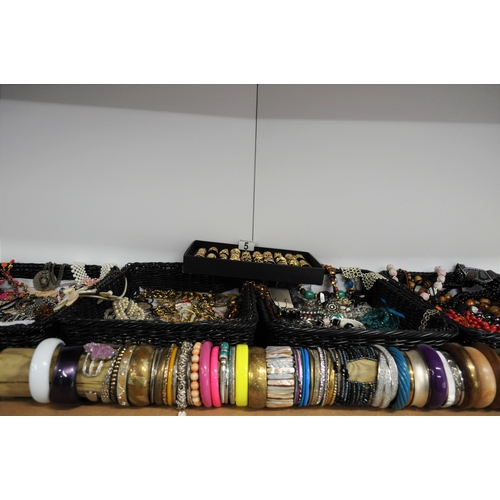 5 - A large quantity of costume jewellery to include necklaces, bracelets, bangles, earrings, rings etc.