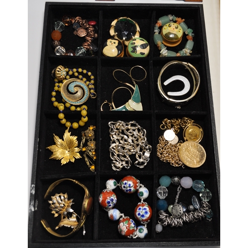 9 - A quantity of costume jewellery of which some items are silver, consisting of rings, necklaces, broo... 