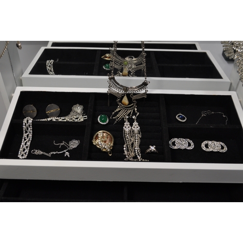 11 - A quantity of costume jewellery to include a selection of different watches, rings, necklaces, brooc... 