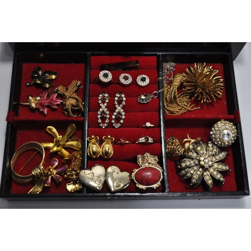 12 - A quantity of costume jewellery to include rings, necklaces, brooches, bracelets, etc. to include so... 