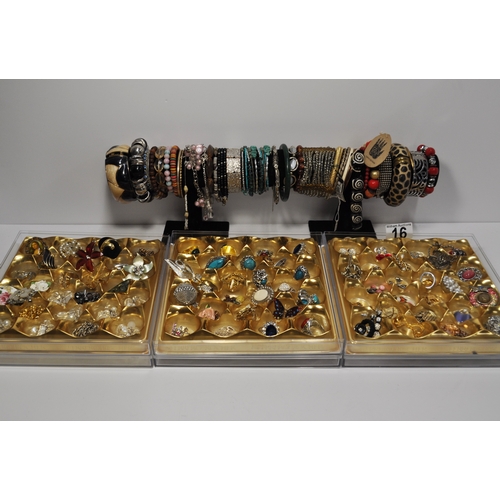 16 - A large quantity of costume jewellery to include brooches, pendants, rings, colourful bangle/bracele... 