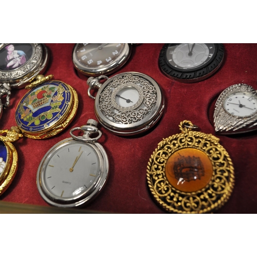 105 - A large quantity of novelty pocket watches (x34) presented in a three drawer display unit measuring ... 