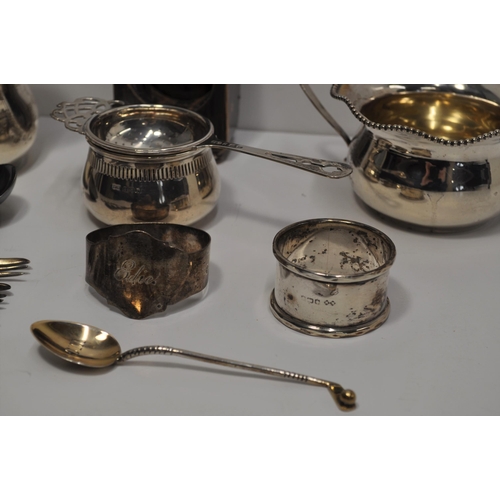 130 - Vintage and antique silver items matching sugar and cream jug, napkin rings, tea strainer, traveling... 