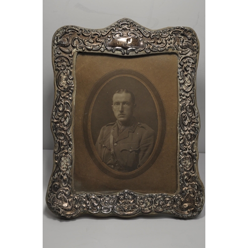 133 - Antique photo frame of repousse design, hallmarked Chester 1906, with portraiture of serviceman, app... 