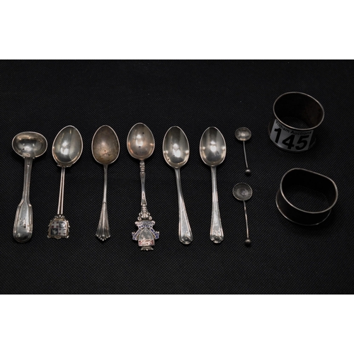 145 - A collection of silver spoons with different decorative handle designs together with two napkin ring... 