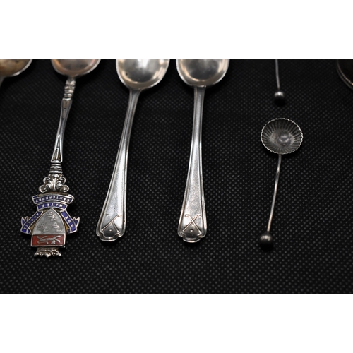 145 - A collection of silver spoons with different decorative handle designs together with two napkin ring... 