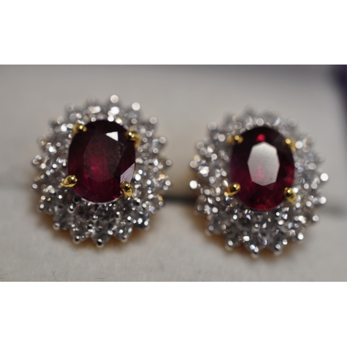 43 - 18ct yellow gold oval cut ruby earrings surrounded by double row of brilliant cut diamonds, approx. ... 