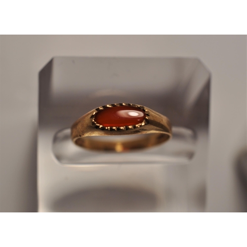 48 - 9ct yellow gold rings (x2), one featuring a red stone cluster approx. size O, one with oval cabochon... 