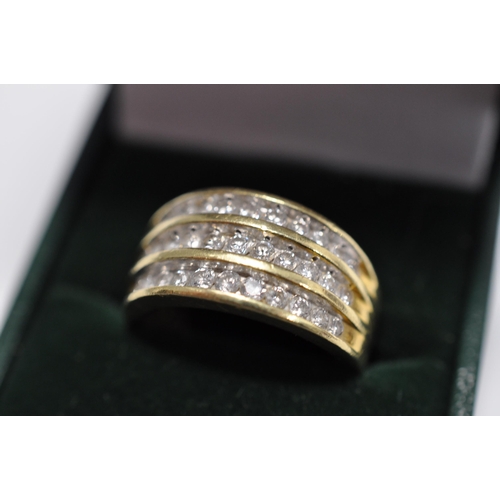 50 - A 18ct yellow gold ring with three rows of graduating diamonds hallmarked London 750, approx. gross ... 