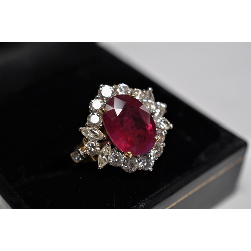 42 - 18ct yellow gold Ruby and diamond cluster ring, set with central oval ruby of approximately 4ct, sur... 