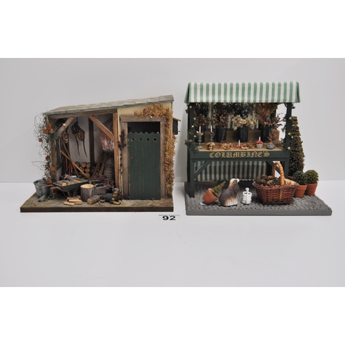 92 - Diorama scene of a flower stand with various items displayed and barn shed scene with various items ... 