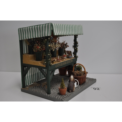 92 - Diorama scene of a flower stand with various items displayed and barn shed scene with various items ... 