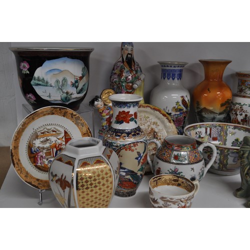 29 - Group of oriental items to include a pair of foo dogs, vases, jugs, and hand-painted famille rose bo... 