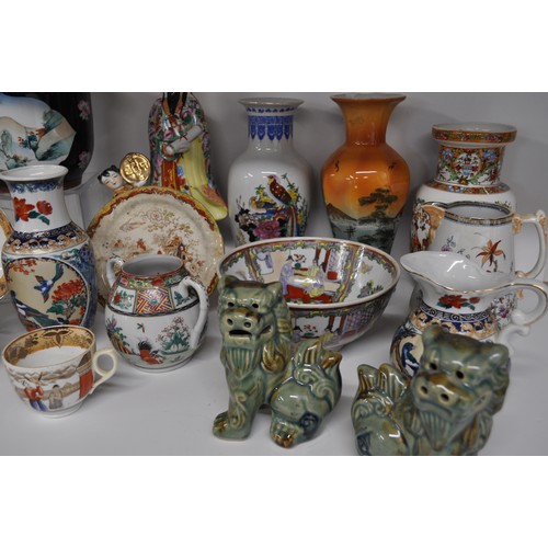 29 - Group of oriental items to include a pair of foo dogs, vases, jugs, and hand-painted famille rose bo... 