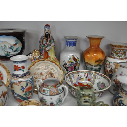 29 - Group of oriental items to include a pair of foo dogs, vases, jugs, and hand-painted famille rose bo... 