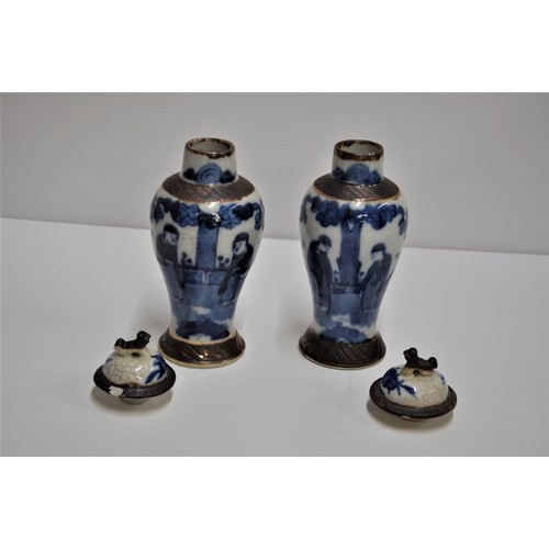 46 - A pair of oriental crackle glazed lidded vases with foo dog design to lid, marks to base.  Approx. h... 