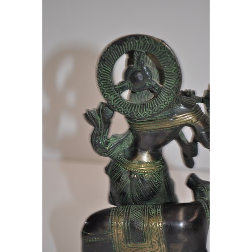 57 - Heavy cast figure of Hindu god Krishna, approx. H 20cm X W 10cm X D 7cm