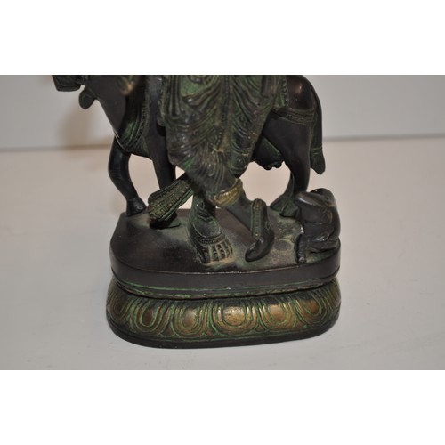 57 - Heavy cast figure of Hindu god Krishna, approx. H 20cm X W 10cm X D 7cm