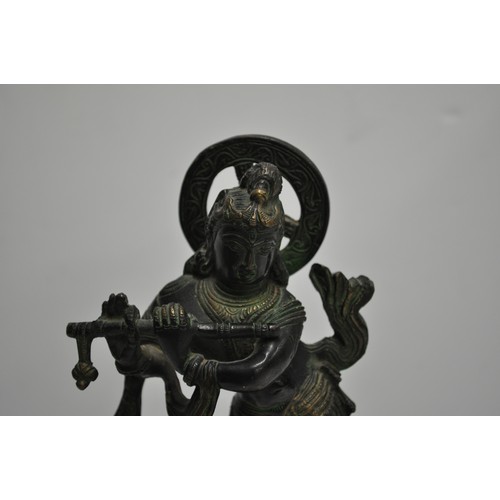 57 - Heavy cast figure of Hindu god Krishna, approx. H 20cm X W 10cm X D 7cm