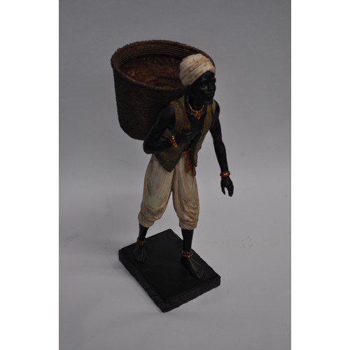 62 - African figure depicting man carrying fruit basket approx. H61cm