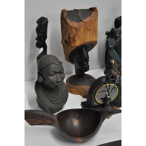 63 - A group of predominantly African style figures and busts. Made from materials of wood, resin, and me... 