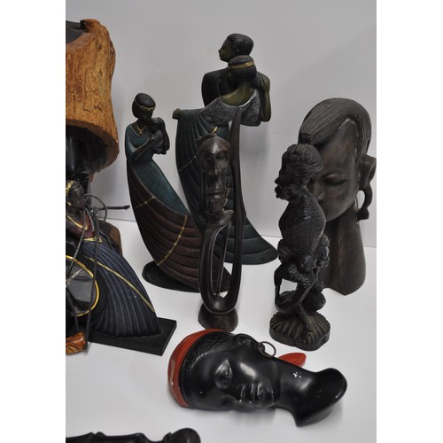 63 - A group of predominantly African style figures and busts. Made from materials of wood, resin, and me... 