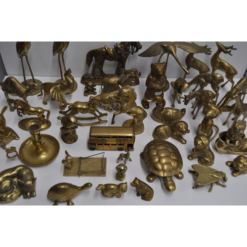 80 - A large quantity of brass and metalware items in various shapes and designs to include candlestick h... 