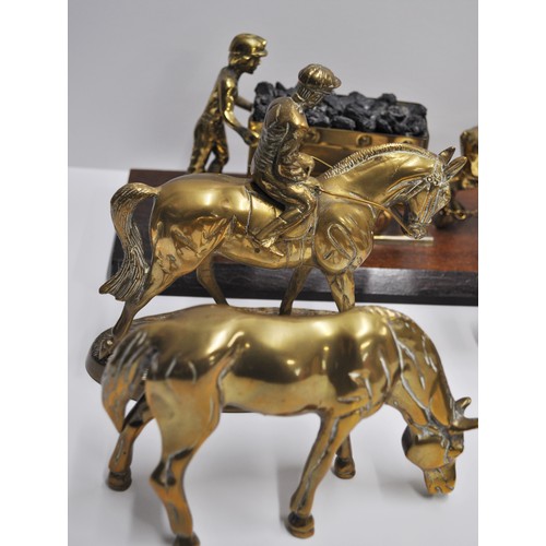 82 - A group of metalware figures consisting of horse and jockey figures and other mining related items, ... 