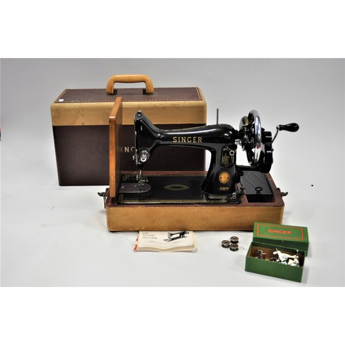 106 - 1950s Singer sewing machine model 99K, serial number EM518565, with case, accessories and booklet