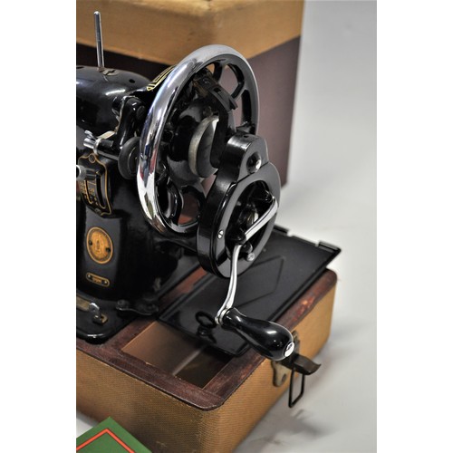 106 - 1950s Singer sewing machine model 99K, serial number EM518565, with case, accessories and booklet