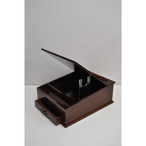 110 - A mahogany writing slope together with a hand-carved cigarette dispenser depicting a bird on the bob... 