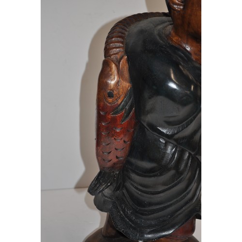 111 - Carved wooden statue of Chinese fisherman returning with his catch, approx. H 53cm