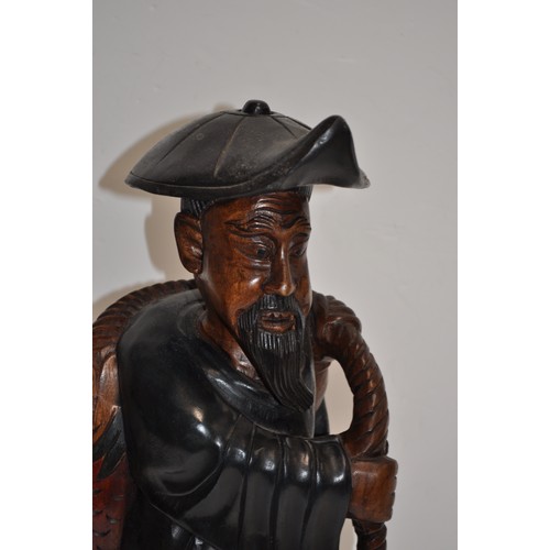 111 - Carved wooden statue of Chinese fisherman returning with his catch, approx. H 53cm