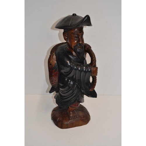 111 - Carved wooden statue of Chinese fisherman returning with his catch, approx. H 53cm