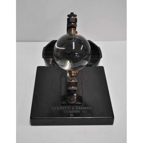 124 - 'Rare' Negretti and Zambra sunshine recorder with glass sphere in black metal mounts on a slate base...