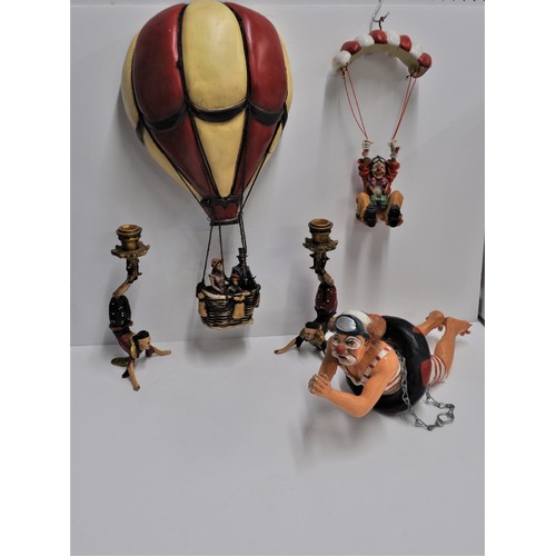 129 - A pair of acrobat candlesticks together with other comical clown figure items