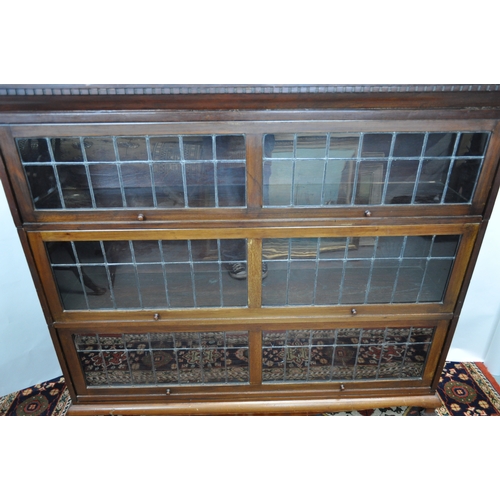 139 - Three-section bookcase with up and over leaded glass fronts, can be disassembled for easy transport,... 