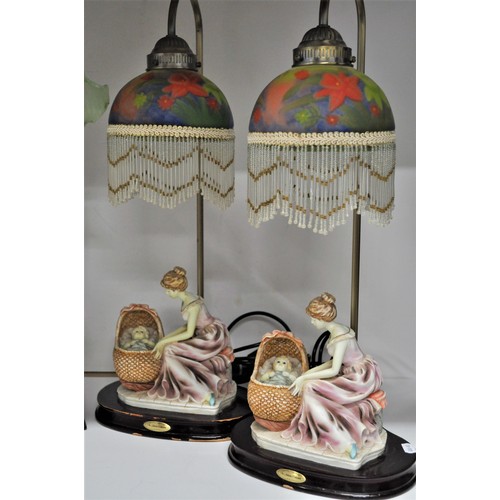 162 - Juliana Lamps - Consisting of a pair of lamps with mother and child figures and 
decorative beaded g... 