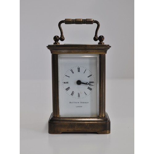 163 - x2 Matthew Norman brass carriage clocks of varying size, engraved '11 jewels' with a bevelled glass ... 