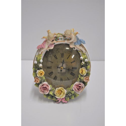 168 - Dyson and Sons boudoir clock featuring coloured roses and cherubs on a porcelain surround, stamped S... 