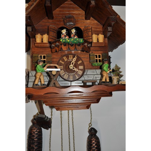 177 - Schneider German cuckoo clock depicting dancing couples and woodman at work, with weights, untested