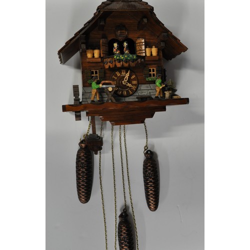 177 - Schneider German cuckoo clock depicting dancing couples and woodman at work, with weights, untested