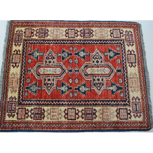 181 - Persian rug with mirrored pattern to centre, bright colours and fringe approx. size L107cm X W85cm