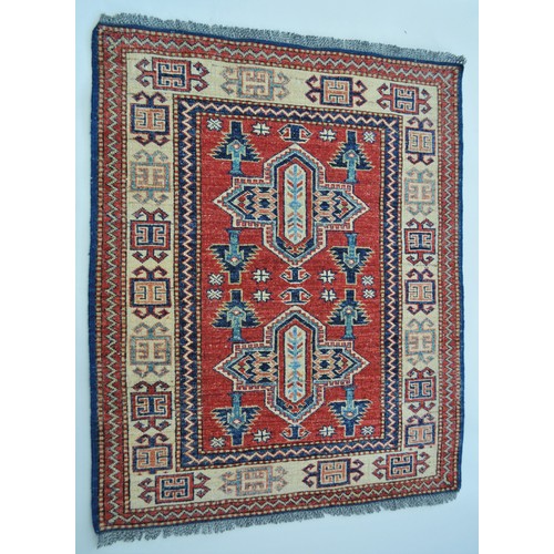 181 - Persian rug with mirrored pattern to centre, bright colours and fringe approx. size L107cm X W85cm