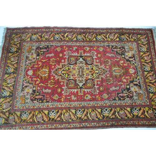 182 - Persian / Turkish Rug with geometric patterning to centre and flora design to borders with fringing,... 